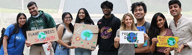 A collection of students holding signs in support of Earth Week.