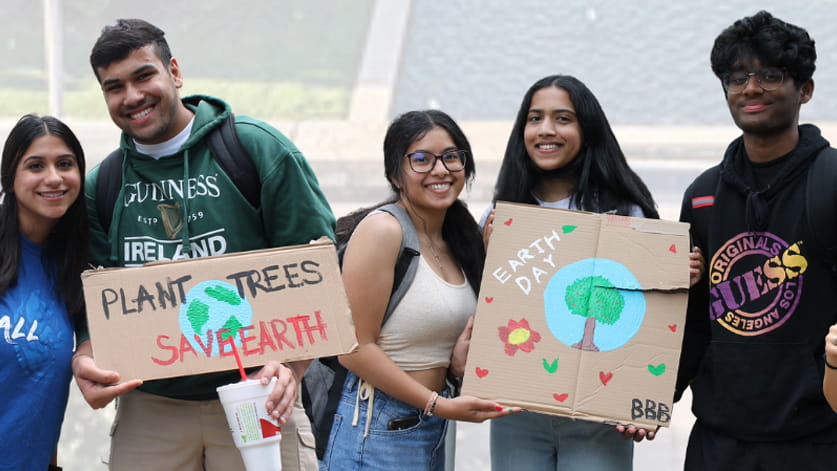 Students with signs for Earth Week